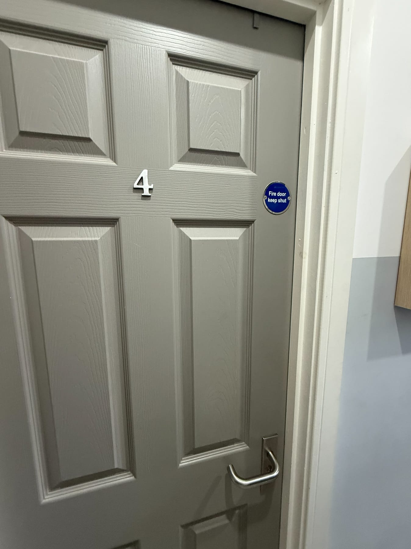 Room fire door with keep-shut sign, current condition 2026
