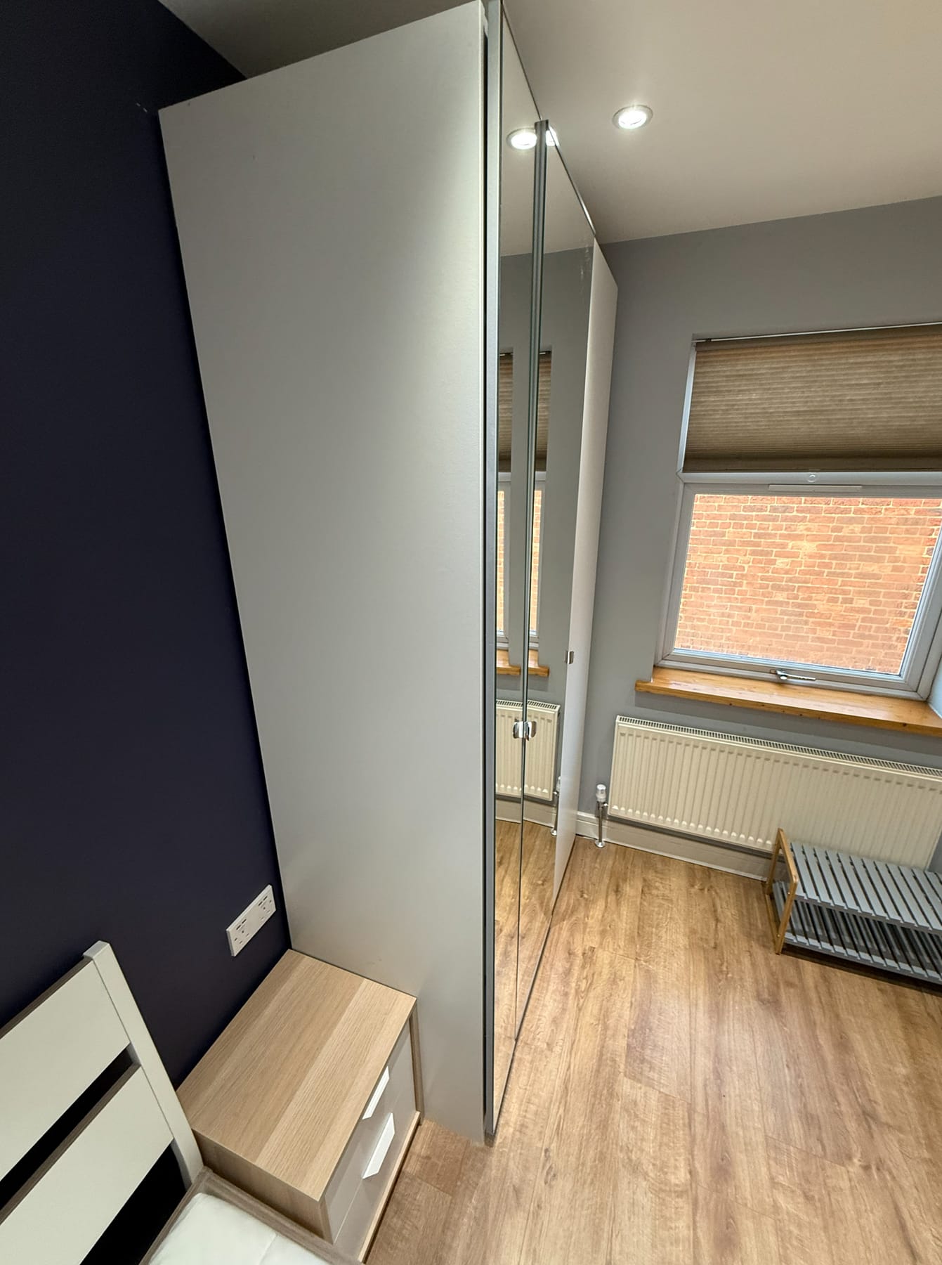 Room with mirrored wardrobe and window, current condition